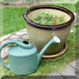 L03. Planter and plastic watering can. 